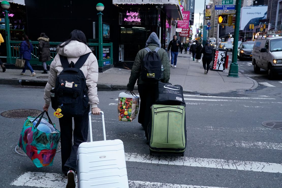 A migrant family leaves the Row Hotel in midtown Manhattan on January 10.