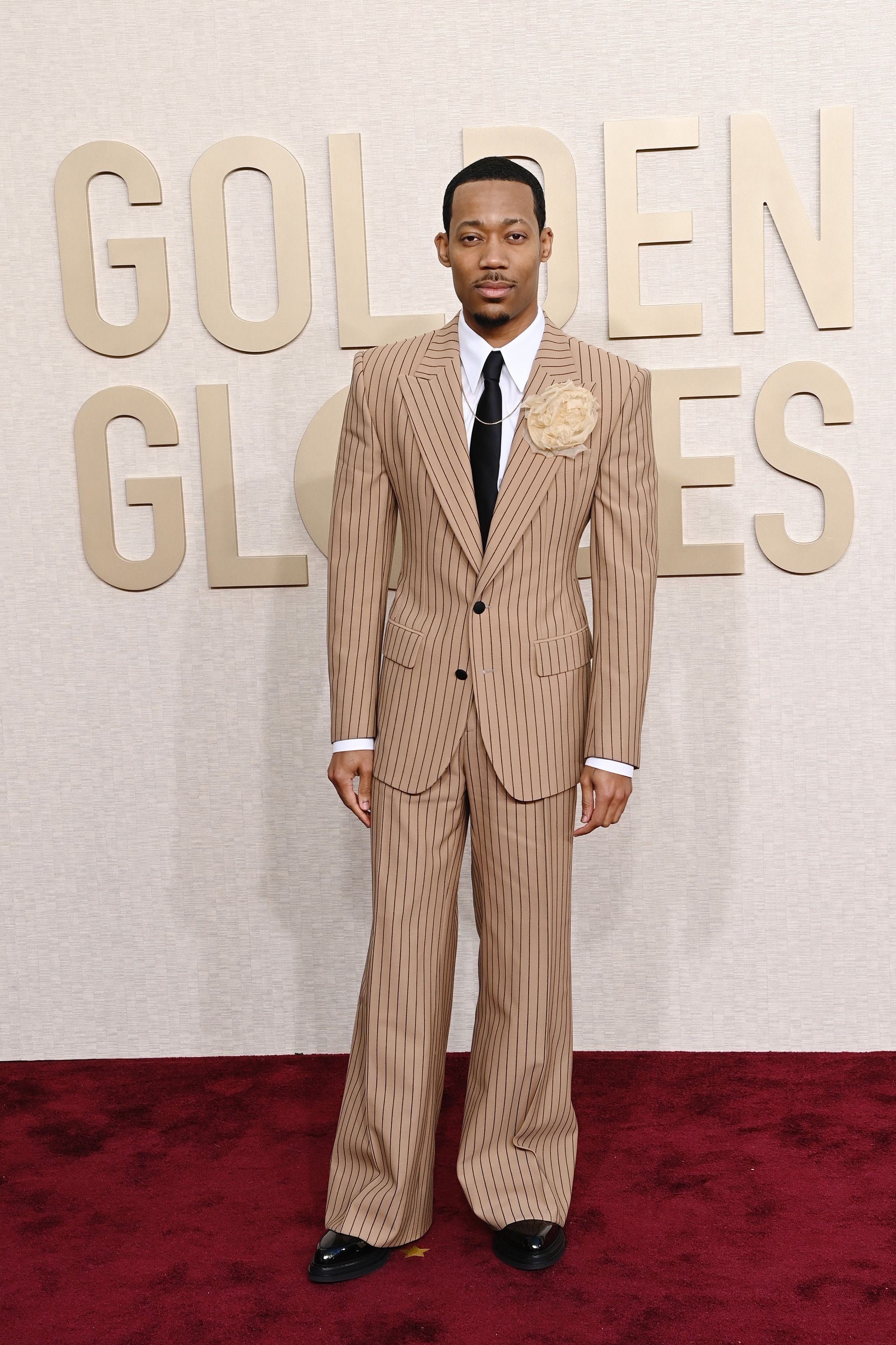 “Abbott Elementary” star Tyler James Williams wore a wide-legged pinstripe Dolce & Gabbana suit accessorized with a rosette brooch and David Yurman necklace.