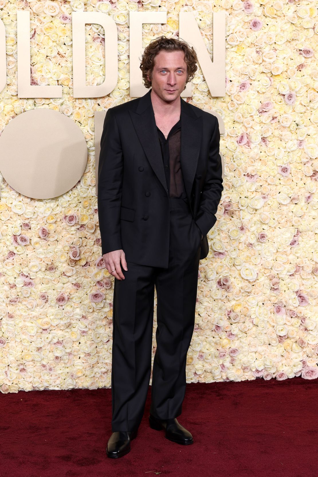 “The Bear” actor Jeremy Allen White wore a custom black Calvin Klein tuxedo consisting of a double-breasted wool jacket with satin grosgrain lapels, high-waisted trousers and a sheer silk voile shirt.