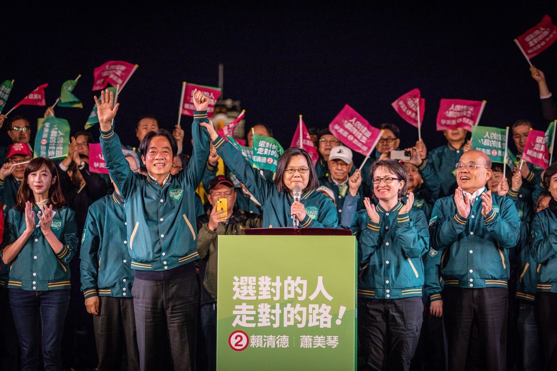 Tsai holds up Lai's hand at a DPP campaign rally in Taipei just days before Taiwan's presidential election on January 13, 2014.