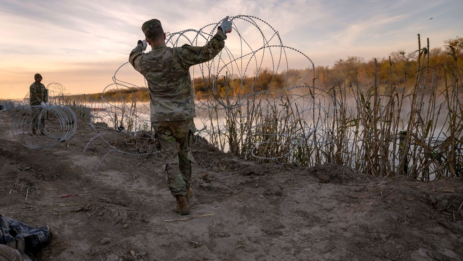 Texas National Guard soldiers install additional razor wire lie along the Rio Grande on January 10 in Eagle Pass, Texas.