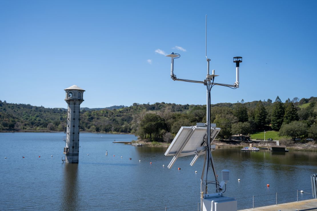 A weather monitoring station with solar panels and antenna overlooking Lafayette Reservoir, California, March 24, 2023.