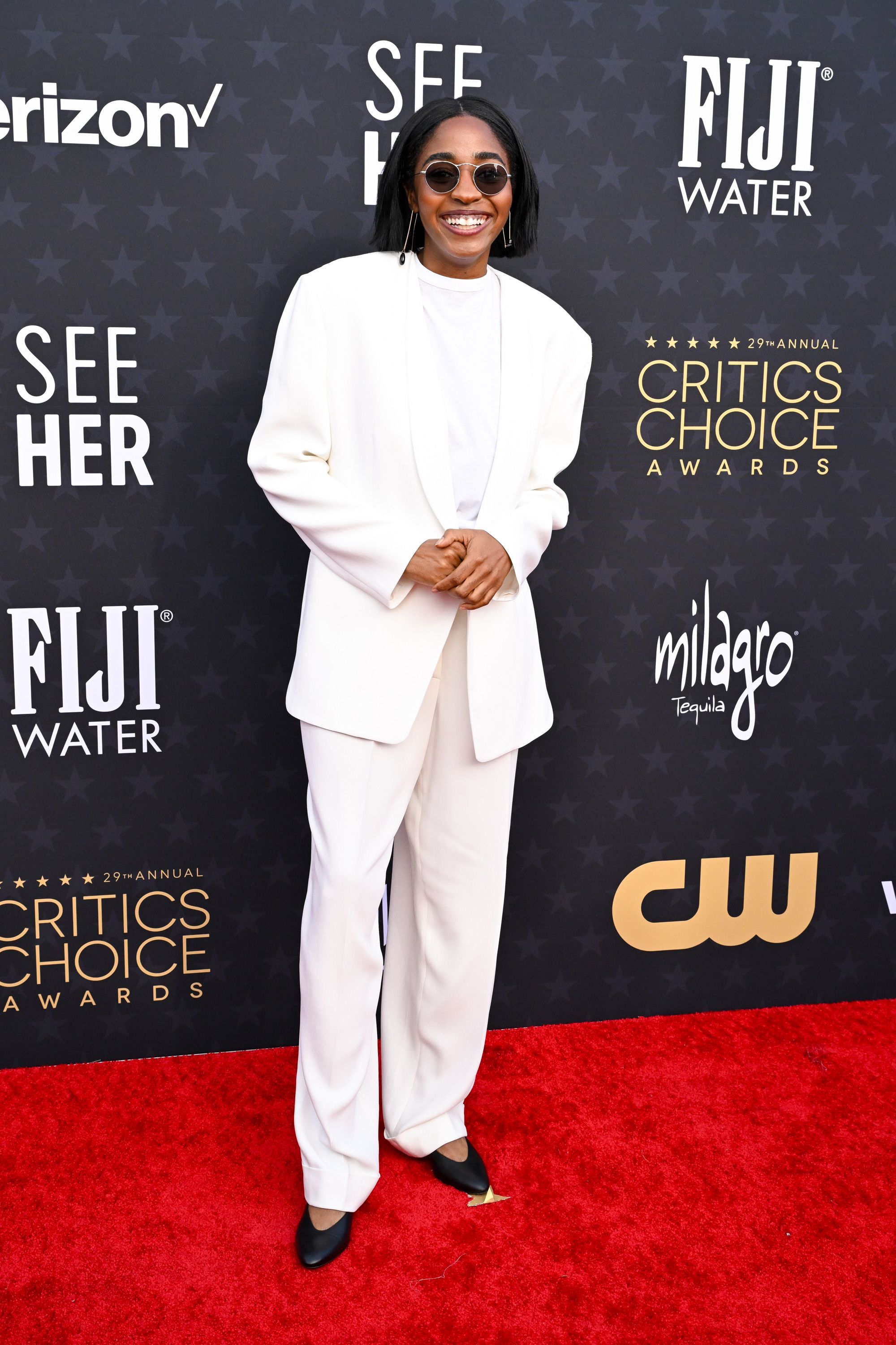 “The Bear” actress Ayo Edebiri arrived in an all-white suit by the The Row and Oliver Peoples sunglasses.