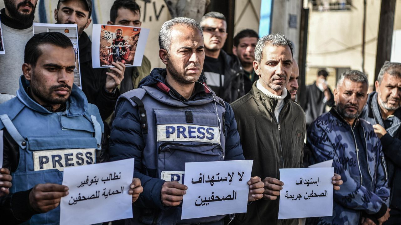 RAFAH, GAZA - JANUARY 15: Members of the press, who try to perform their duties in the Gaza Strip, carry banners reading 'the press is free and cannot be silenced' during a demonstration due to being targeted by the Israeli army, in front of Kuwait Hospital of Rafah city, Gaza on January 15, 2024. (Photo by Abed Zagout/Anadolu via Getty Images)