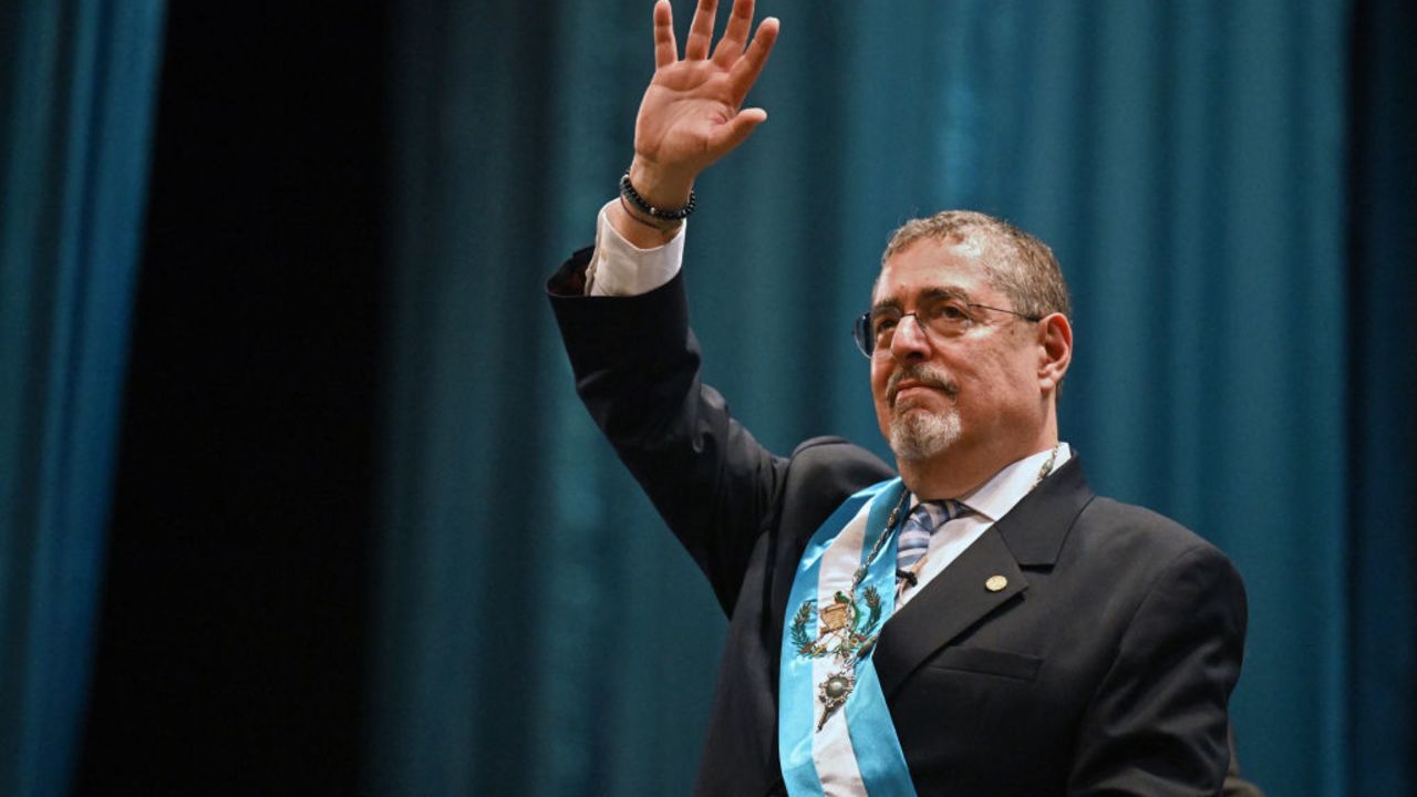 TOPSHOT - Guatemala's new President Bernardo Arevalo waves after swearing in during his inauguration ceremony at the Miguel Angel Asturias Cultural Centre in Guatemala City, early on January 15, 2024. Bernardo Arevalo was finally sworn in as Guatemala's president early Monday after the ceremony was delayed for more than nine hours, capping months of judicial machinations to block the anti-corruption crusader from taking office. (Photo by Johan ORDONEZ / AFP) (Photo by JOHAN ORDONEZ/AFP via Getty Images)