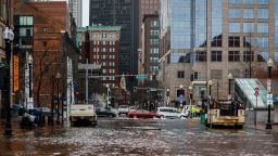 Cars travel through high floodwaters in Boston during high tide. New England residents were greeted with a coastal flood warning for the entire coast of Rhode Island and Massachusetts on up to Maine.