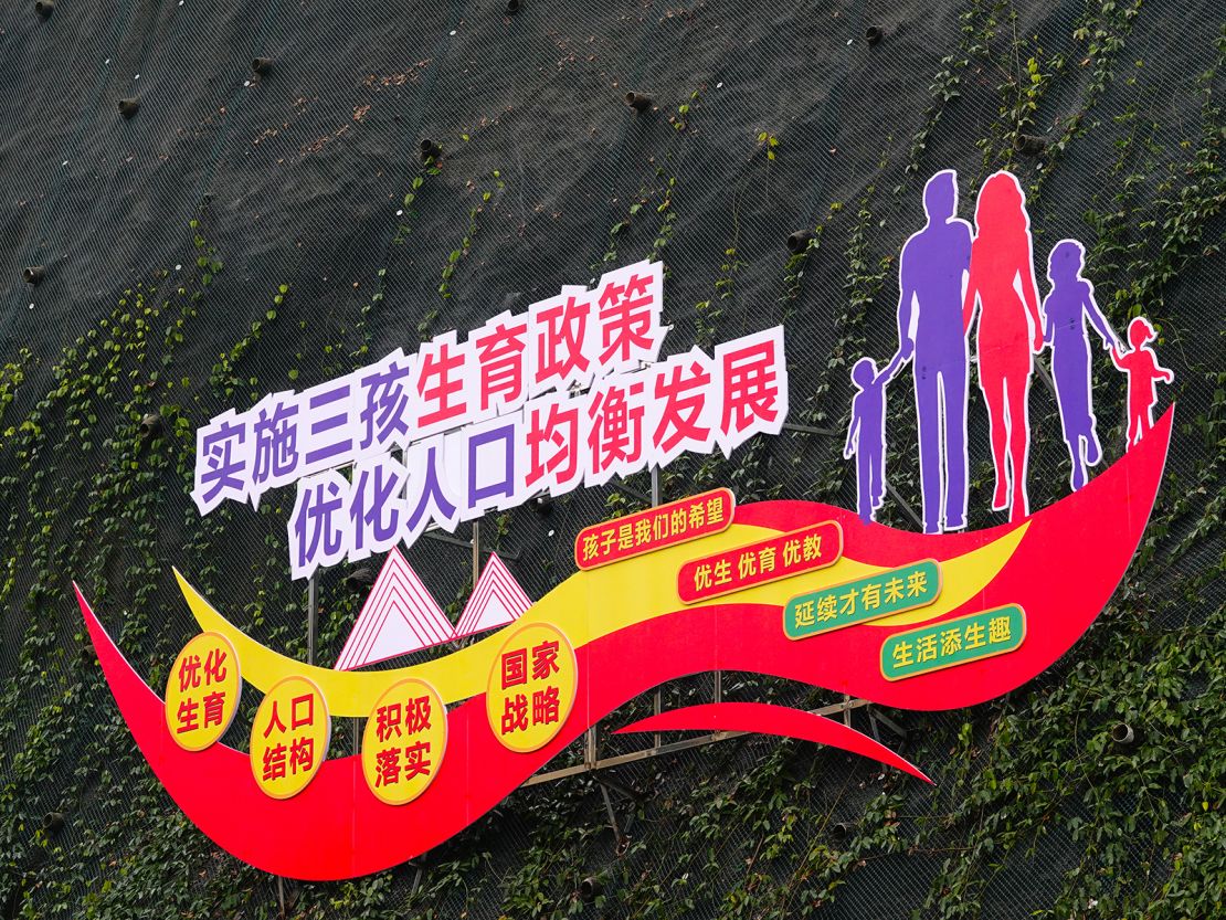 A billboard says, "Implement three-child policy and optimize population growth" in Yichang, Hubei province of China, on January 17, 2024.