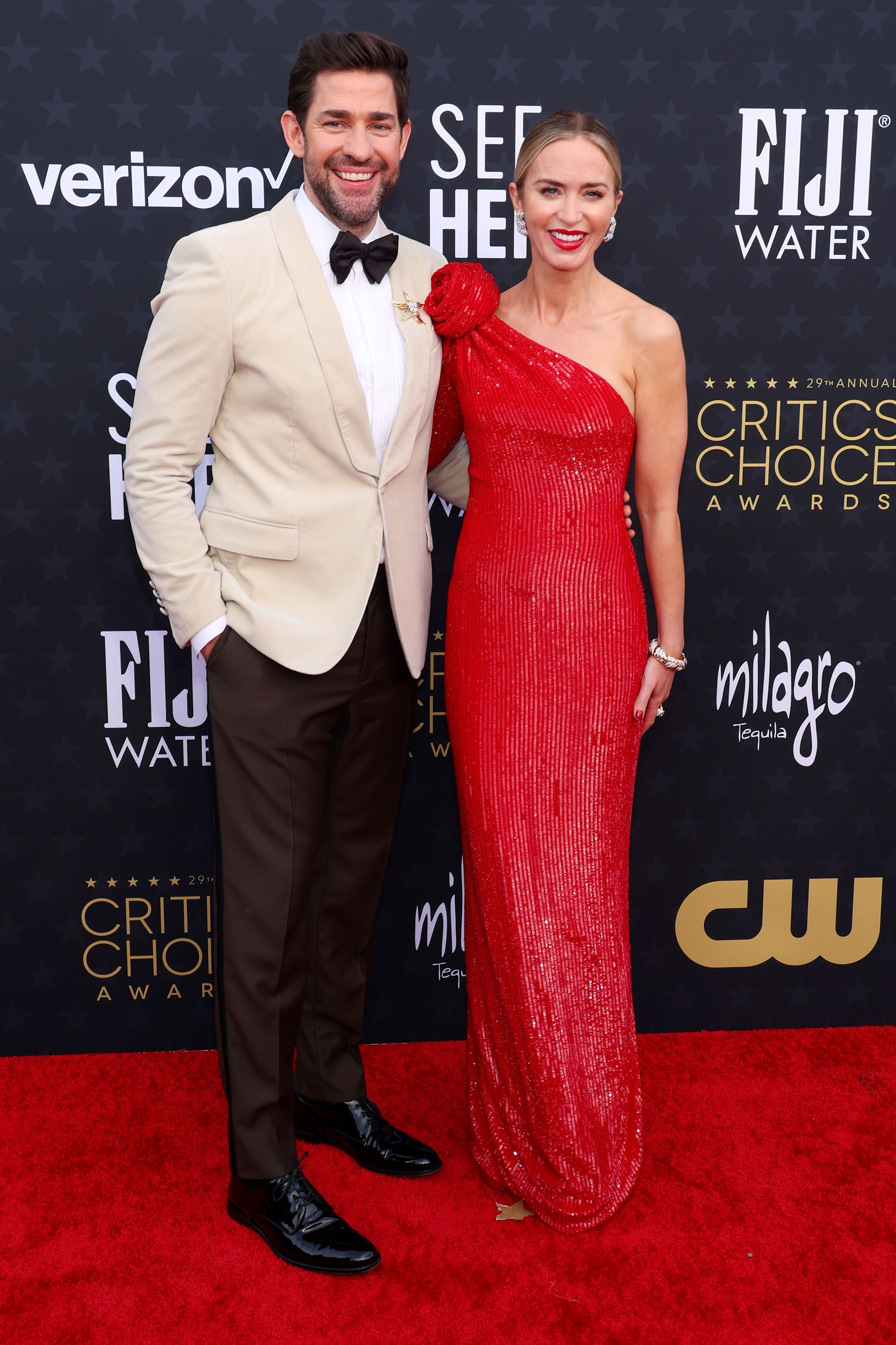 John Krasinski wore an off-white Dolce & Gabbana tuxedo jacket with black pants and bowtie, while Emily Blunt was in a sleek red Giorgio Armani Privé dress with a rosette detail and Tiffany & Co. jewelry.