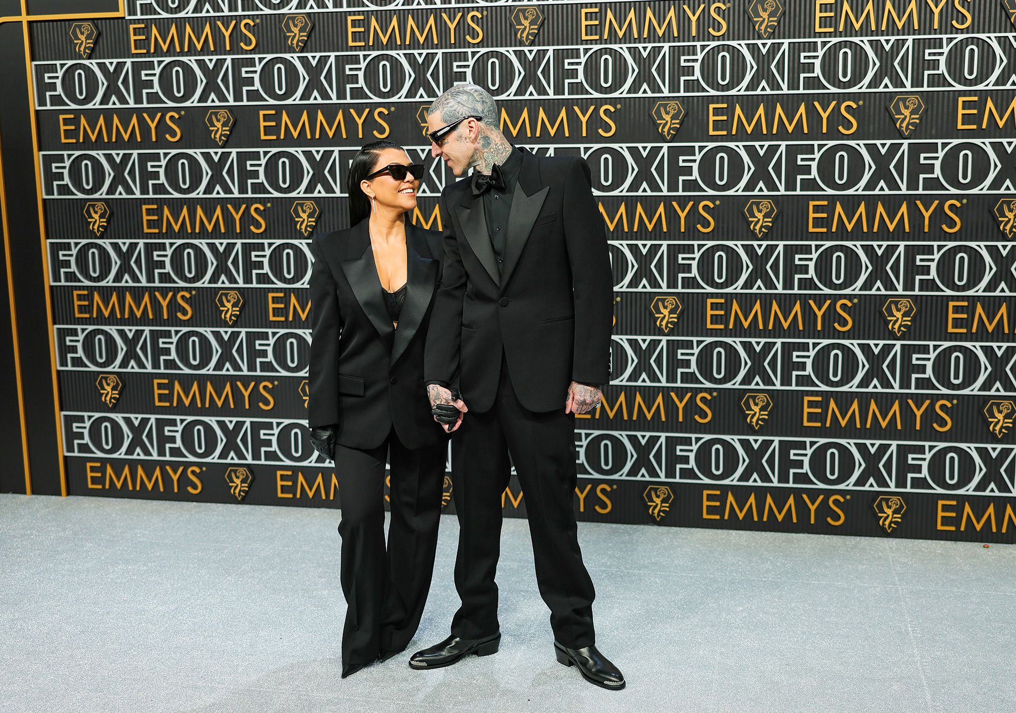 Kourtney Kardashian and Travis Barker wore his-and-hers tuxes.