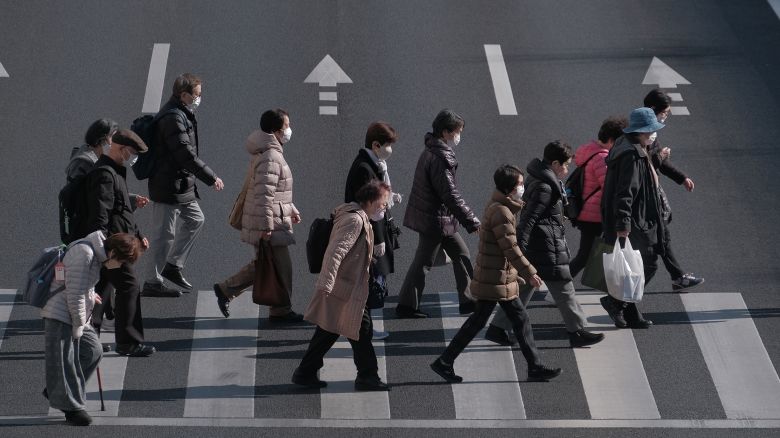 Pedestrians cross an intersection in the Itabashi district of Tokyo, Japan, on Friday, Jan. 19, 2024. Japan's demographic challenges combined with years of slow growth have increased the social welfare burden on the government. Photographer: Soichiro Koriyama/Bloomberg via Getty Images