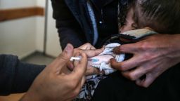 A UNRWA employee provides a polio vaccine in a clinic in Deir al-Balah, in the central Gaza Strip, on January 21, 2024.