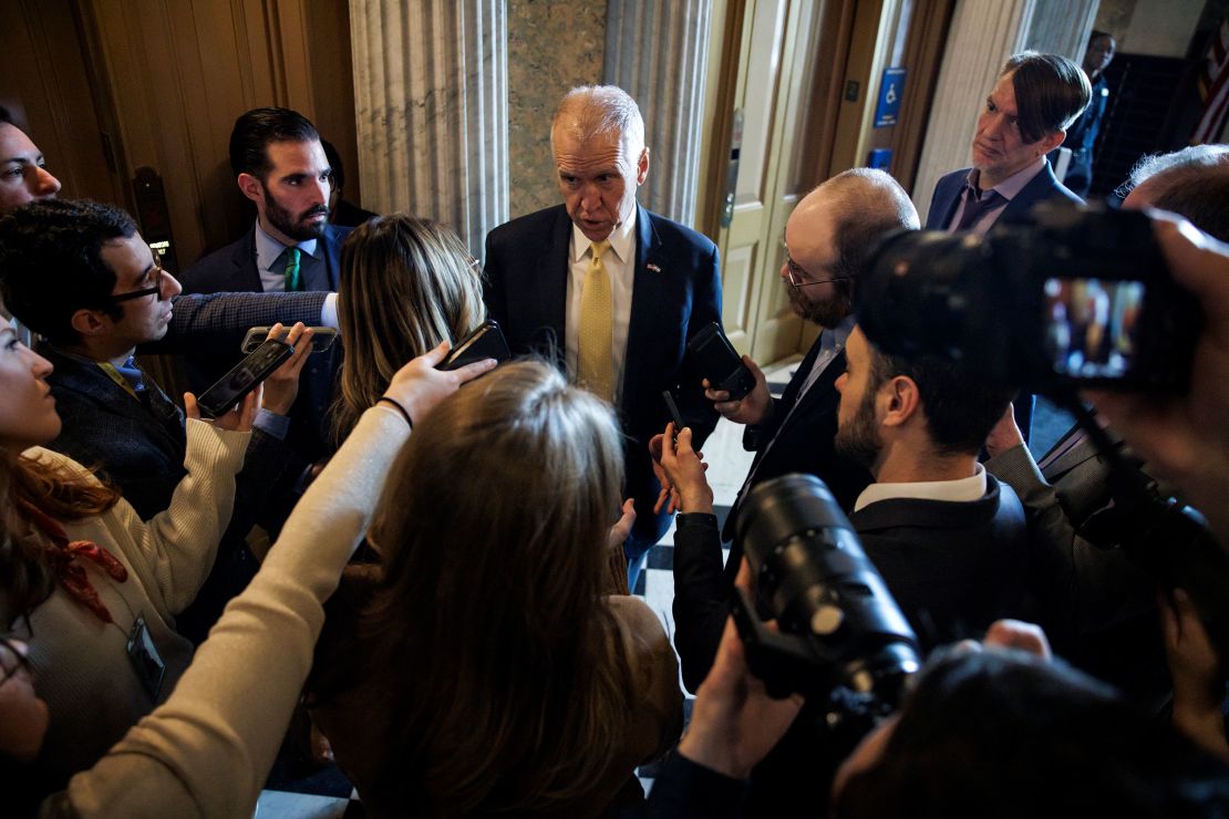 Sen. Thom Tillis talks to reporters as he heads to the Senate floor for a vote on January 23 in Washington, DC.