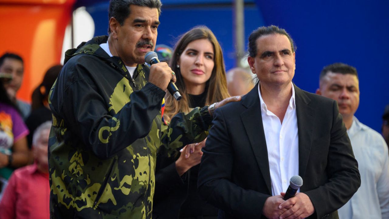 Venezuela's President Nicolas Maduro (L) speaks to supporters next to Colombian-born businessman Alex Saab during a rally in support of his government in Caracas on January 23, 2024. (Photo by Gabriela Oraa / AFP) (Photo by GABRIELA ORAA/AFP via Getty Images)