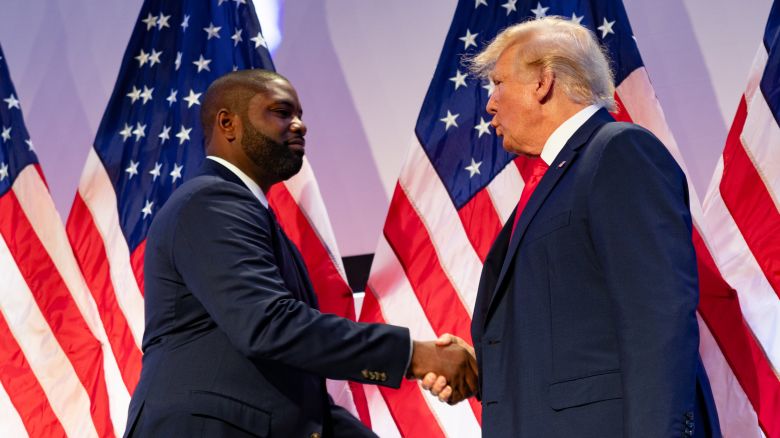 PHILADELPHIA, PENNSYLVANIA - JUNE 30:  (L-R) U.S. Congressman Byron Donalds shakes hands with of Former U.S. President and Republican presidential candidate Donald Trump at the Moms for Liberty Summit in Philadelphia, Pennsylvania, 2023. (Photo by Hannah Beier for the Washington Post.) 