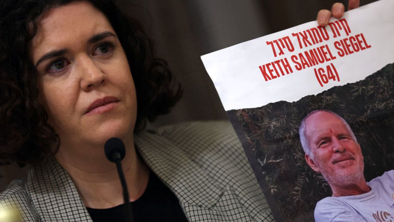 Tal Wax holds a poster with a photograph of her uncle Keith Samuel Siegel, an Israeli-American hostage held in Gaza since the October 7 attacks by Hamas, during a press conference to demand a deal for their release, in Madrid on January 25, 2024. Thousands of civilians, both Palestinians and Israelis, have died since October 7, 2023, after Palestinian Hamas militants based in the Gaza Strip entered southern Israel killing 1,200 people and took 240 people hostage, Israel says, in an unprecedented attack triggering a war declared by Israel on Hamas with retaliatory bombings on Gaza. (Photo by Pierre-Philippe MARCOU / AFP) (Photo by PIERRE-PHILIPPE MARCOU/AFP via Getty Images)