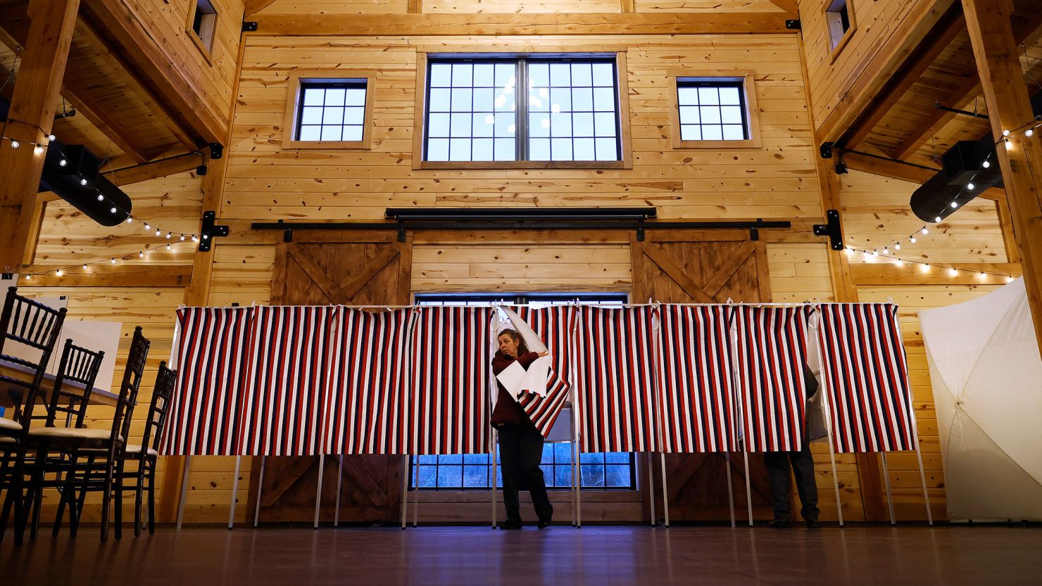 A voter casts her ballot in the New Hampshire presidential primary election at The Barn at Bull Meadow on January 23, 2024, in Concord, New Hampshire.