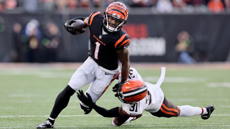 CINCINNATI, OHIO - JANUARY 07: Ja'Marr Chase #1 of the Cincinnati Bengals runs with the ball while defended by Vincent Gray #31of the Cleveland Browns at Paycor Stadium on January 07, 2024 in Cincinnati, Ohio. (Photo by Andy Lyons/Getty Images)