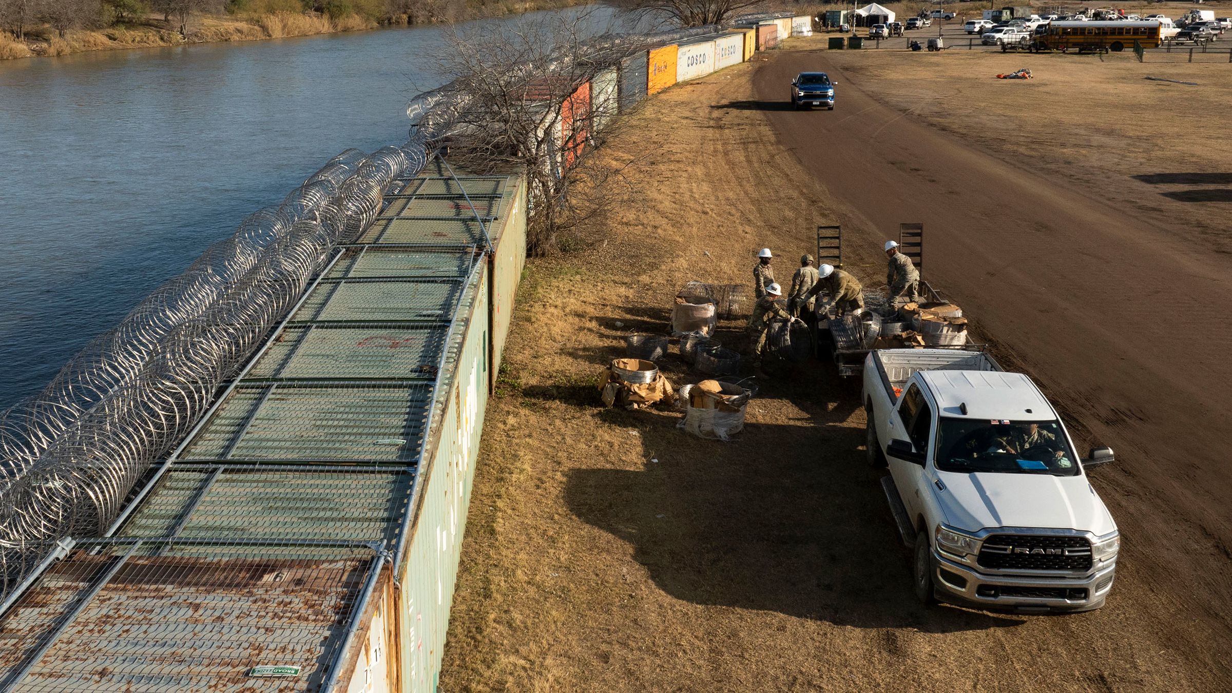 In an aerial view, Texas National Guard soldiers load excess concertina wire onto a trailer at Shelby Park on January 26, 2024, in Eagle Pass, Texas.