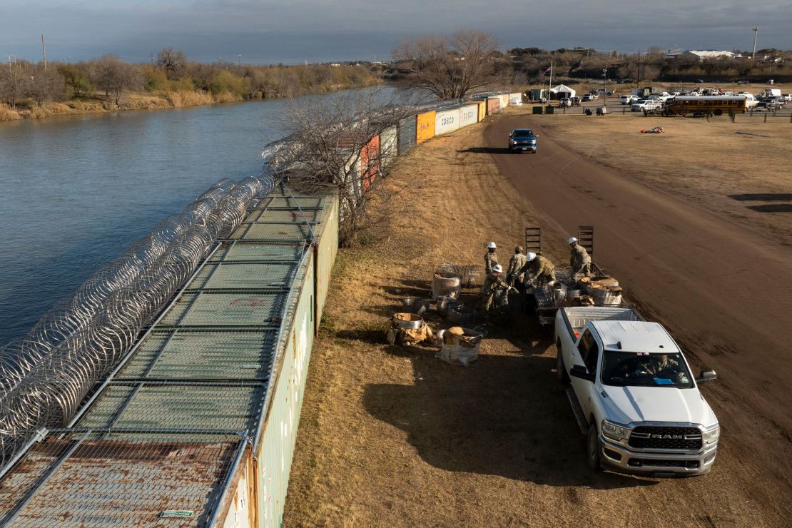 In an aerial view, Texas National Guard soldiers load excess concertina wire onto a trailer at Shelby Park on January 26, 2024 in Eagle Pass, Texas.