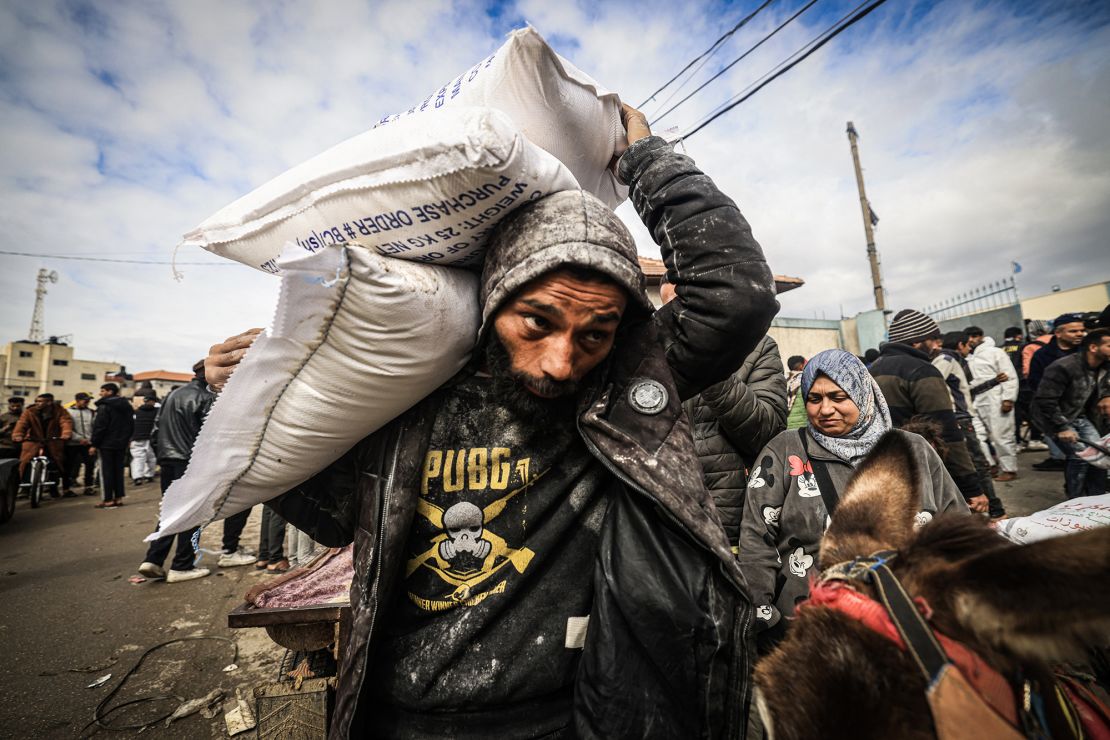 Displaced Palestinians receive food aid at an UNRWA center in Rafah, southern Gaza, in January 2024.