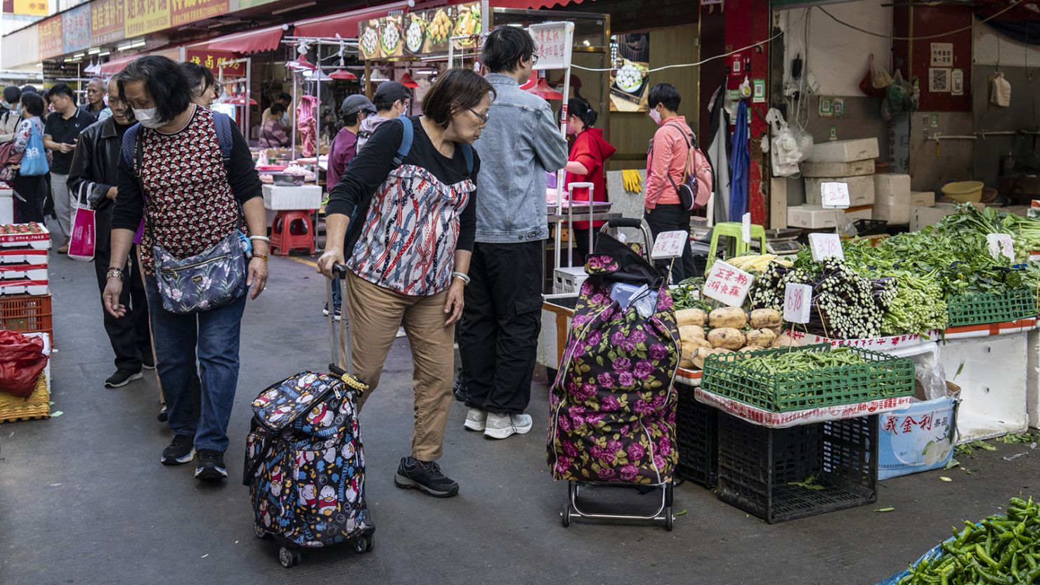 Pedestrians at a wet market in the Jiuxia Village area in Shenzhen, China, on January 19, 2024.