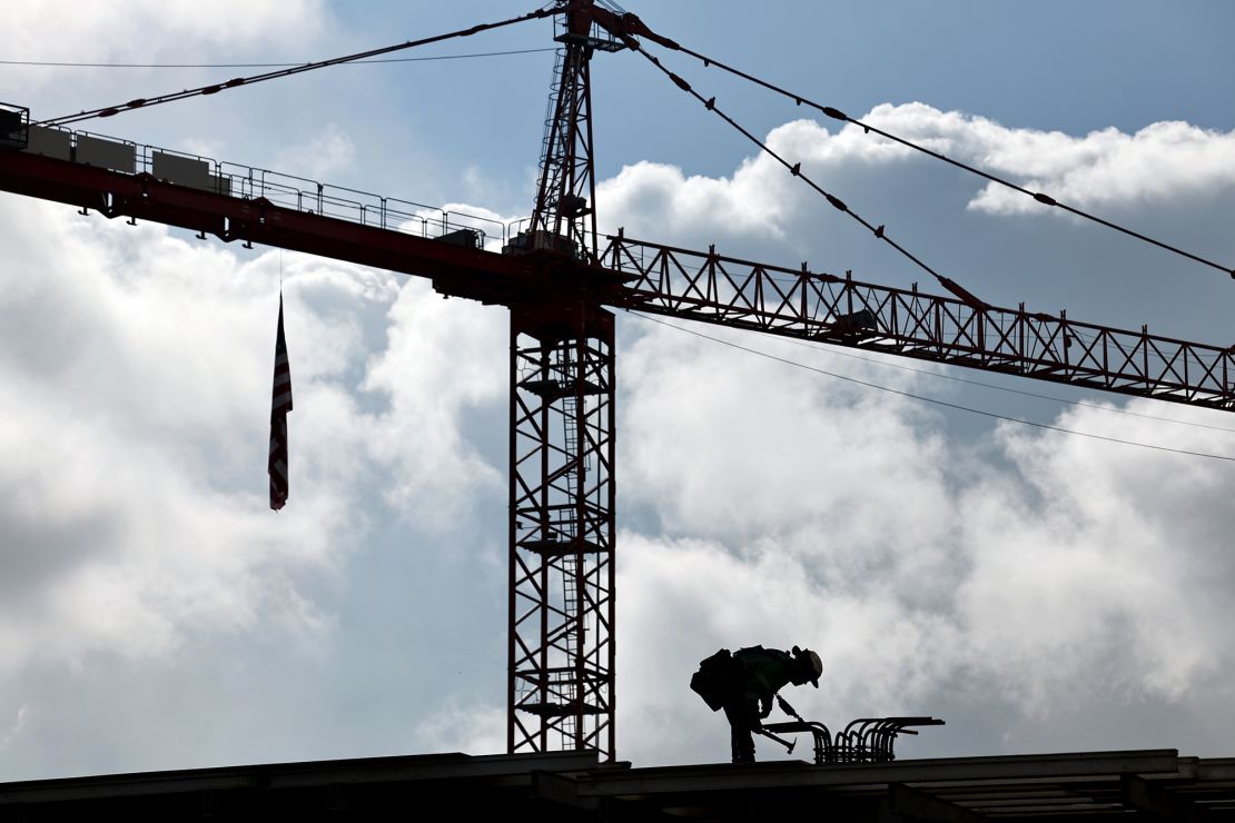 A construction worker helps build a mixed-use apartment complex on January 25, 2024 in Los Angeles.