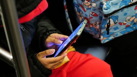 A young boy plays a video game on a smartphone while riding the subway in New York on January 29, 2024. (Photo by Charly TRIBALLEAU / AFP) (Photo by CHARLY TRIBALLEAU/AFP via Getty Images)