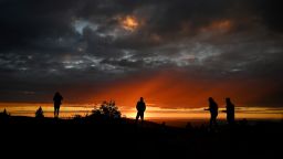 A crowd gathers on the top of Cadillac Mountain to watch the sun set at Acadia National Park Saturday, October 15, 2022.