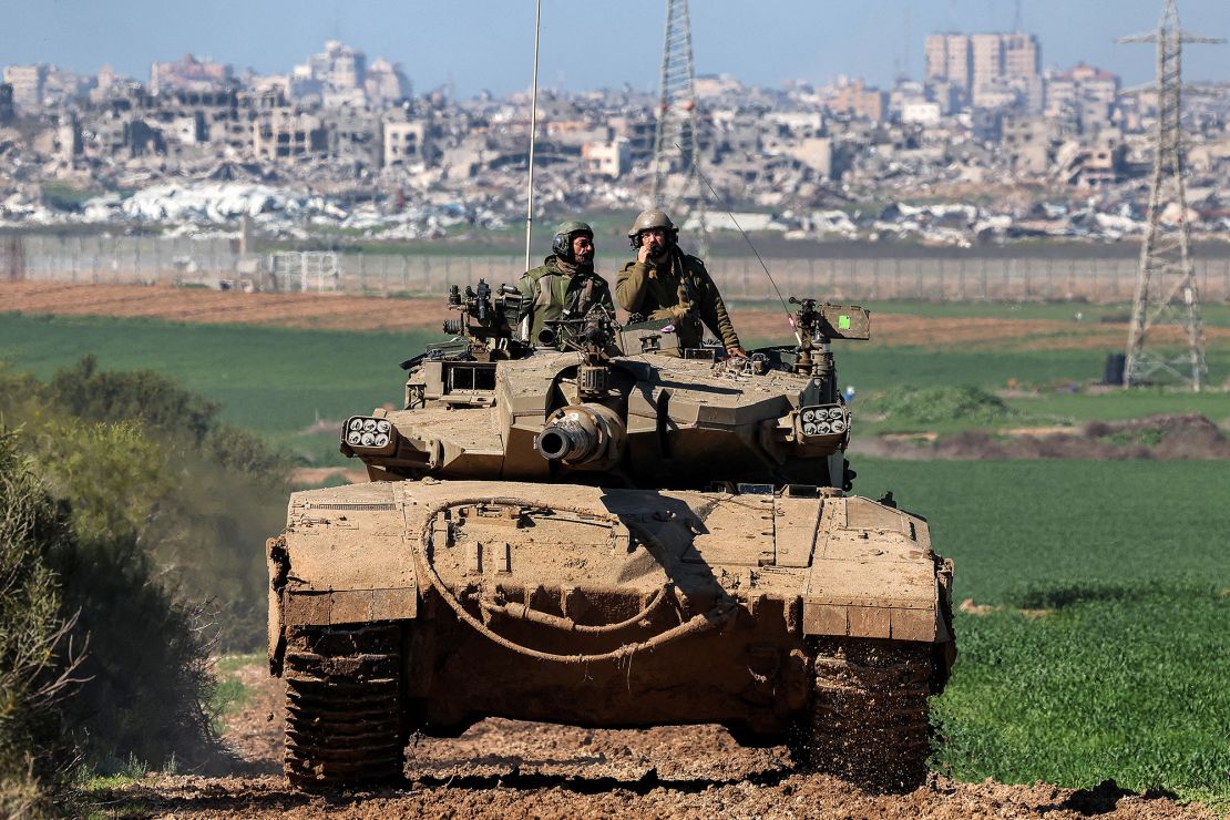 An Israeli tank moves along the border between southern Israeli and Gaza.