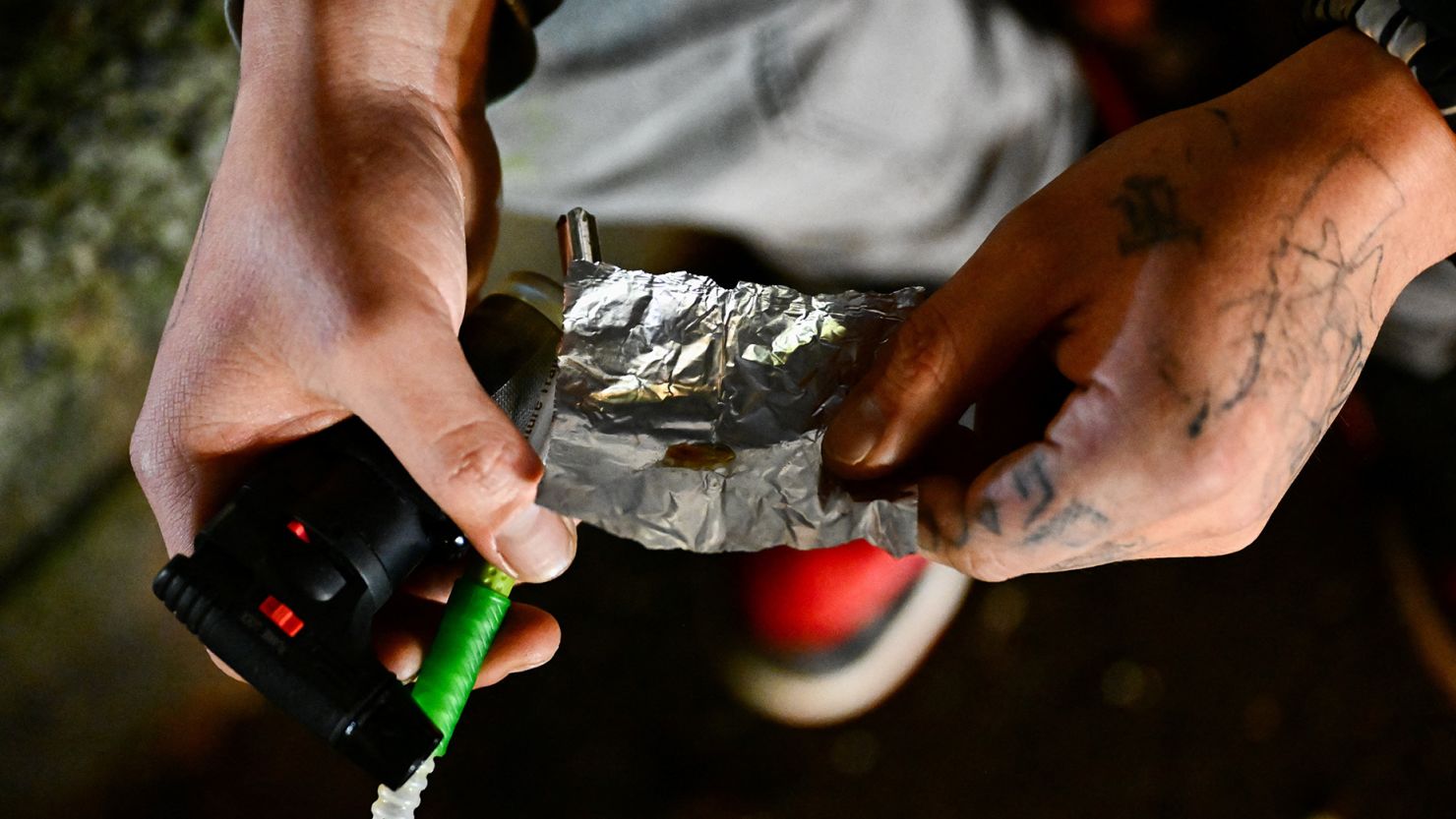 A person is using fentanyl on Park Avenue following the decriminalization of all drugs in downtown Portland, Oregon on January 23, 2024.