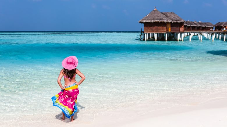 Woman with sarong on a tropical beach, Maldives