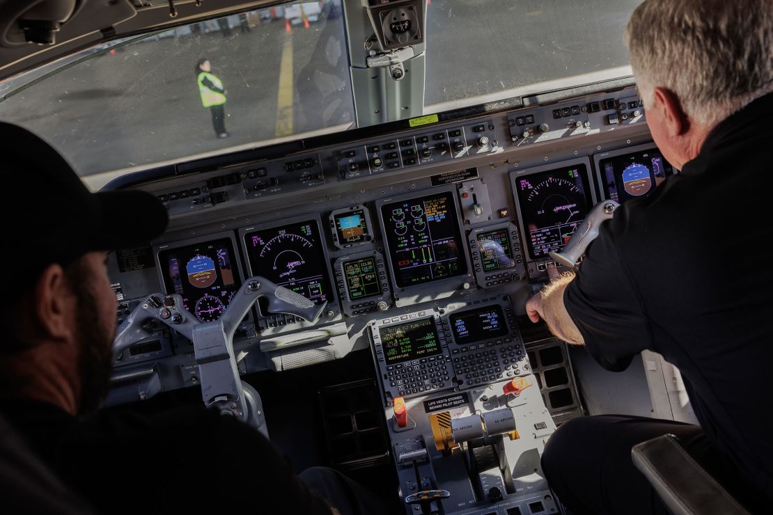 Pilots sit in the cockpit of a charter flight airplane at Dallas Love Field Airport in February 2024.