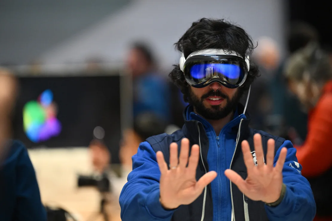 A customer tries on the Apple Vision Pro headset during the product launch at the Apple Store in New York City on February 2, 2024. The Vision Pro, the tech giant's $3,499 headset, was its first major release since the Apple Watch nine years ago. Angela Weiss/AFP/Getty Images