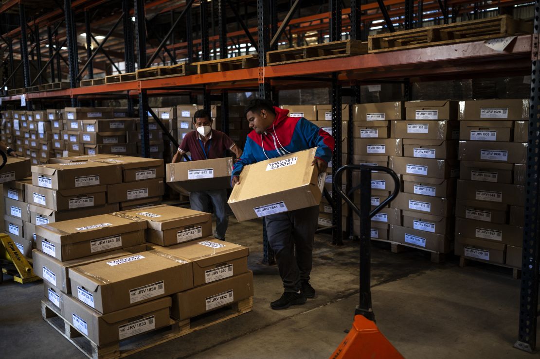 Employees of the Supreme Electoral Tribunal load boxes containing electoral material for the presidential and legislative elections at the Electoral Organization Directorate in San Marcos, El Salvador, on February 2, 2024.