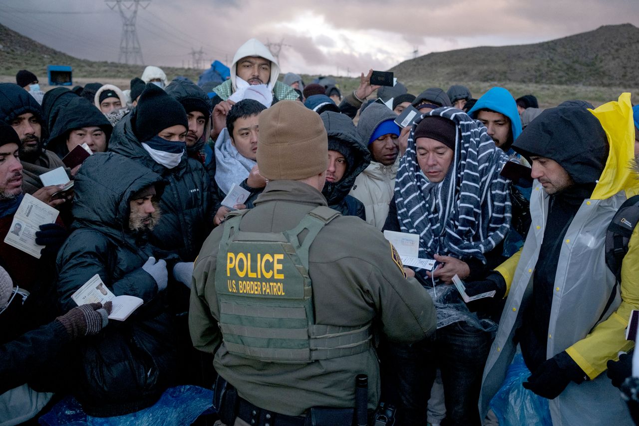 Asylum seekers rush to be processed by border patrol agents at an improvised camp near the US-Mexico border in eastern Jacumba, California, on February 2.