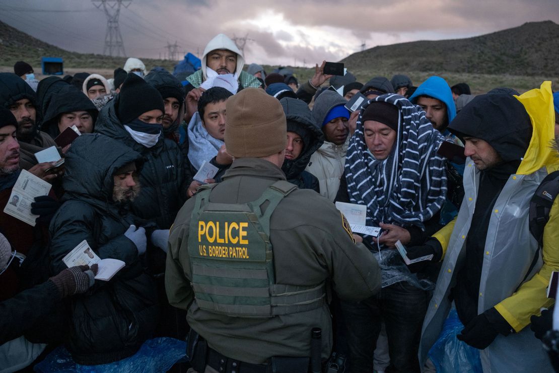Asylum seekers rush to be processed by Border Patrol agents at an improvised camp near the US-Mexico border in eastern Jacumba, California, on February 2, 2024.