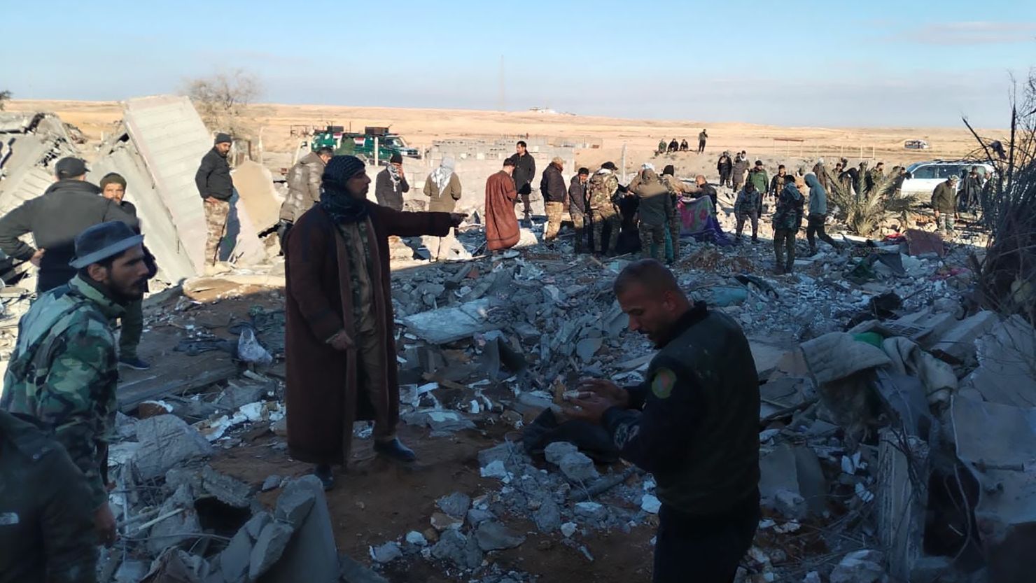 Residents gather around destroyed buildings after US warplanes carried out an airstrike on the headquarters of Hashd al-Shaabi in Al-Qaim city of Anbar, Iraq on February 3.