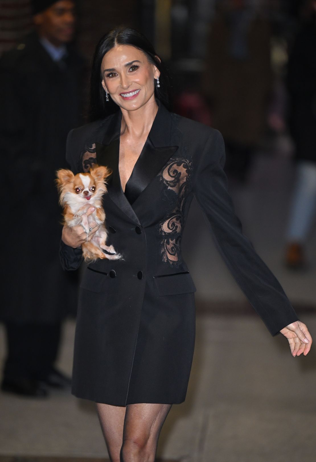 Wearing a Versace lace tailored blazer dress, Moore held Pilaf like a tiny fluffy clutch bag.