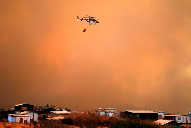 A helicopter works on the zone of a forest fire in the hills in Quilpe comune, Valparaiso region, Chile.