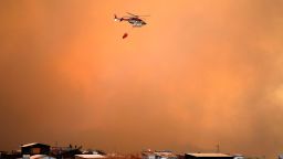 A helicopter works on the zone of a forest fire in the hills in Quilpe comune, Valparaiso region, Chile.
