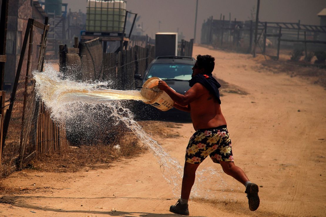 A man puts out a forest fire on the zone of a forest fire in the hills in Quilpe comune, Valparaiso region.