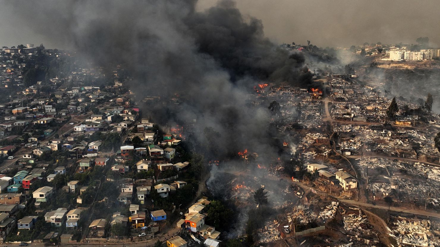 A wildfire reduces homes to rubble and ash on the hills of Viña del Mar, Chile, on February 3.