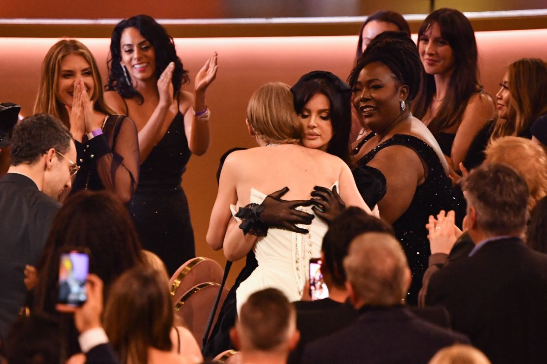 The pop superstar embraces Lana Del Rey at the Grammy Awards on Sunday after winning album of the year for "Midnights."