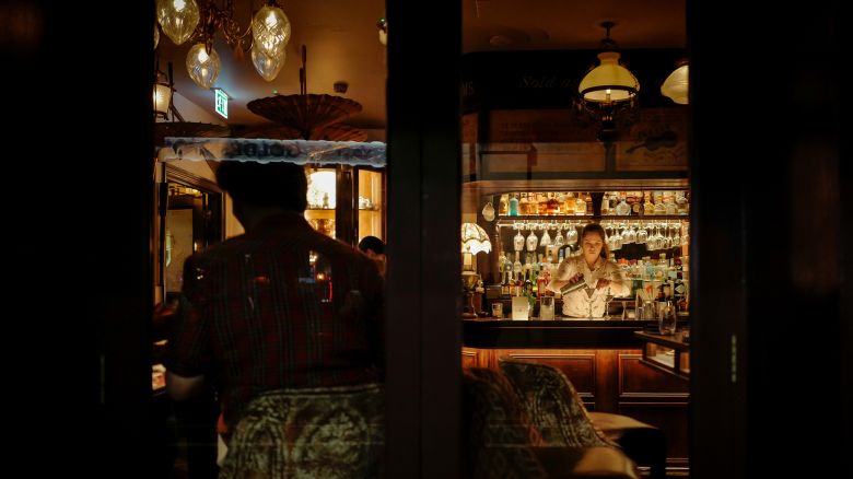 A bartender is working at a bar in Soho, central London, on February 2, 2024. (Photo by Alberto Pezzali/NurPhoto via Getty Images)