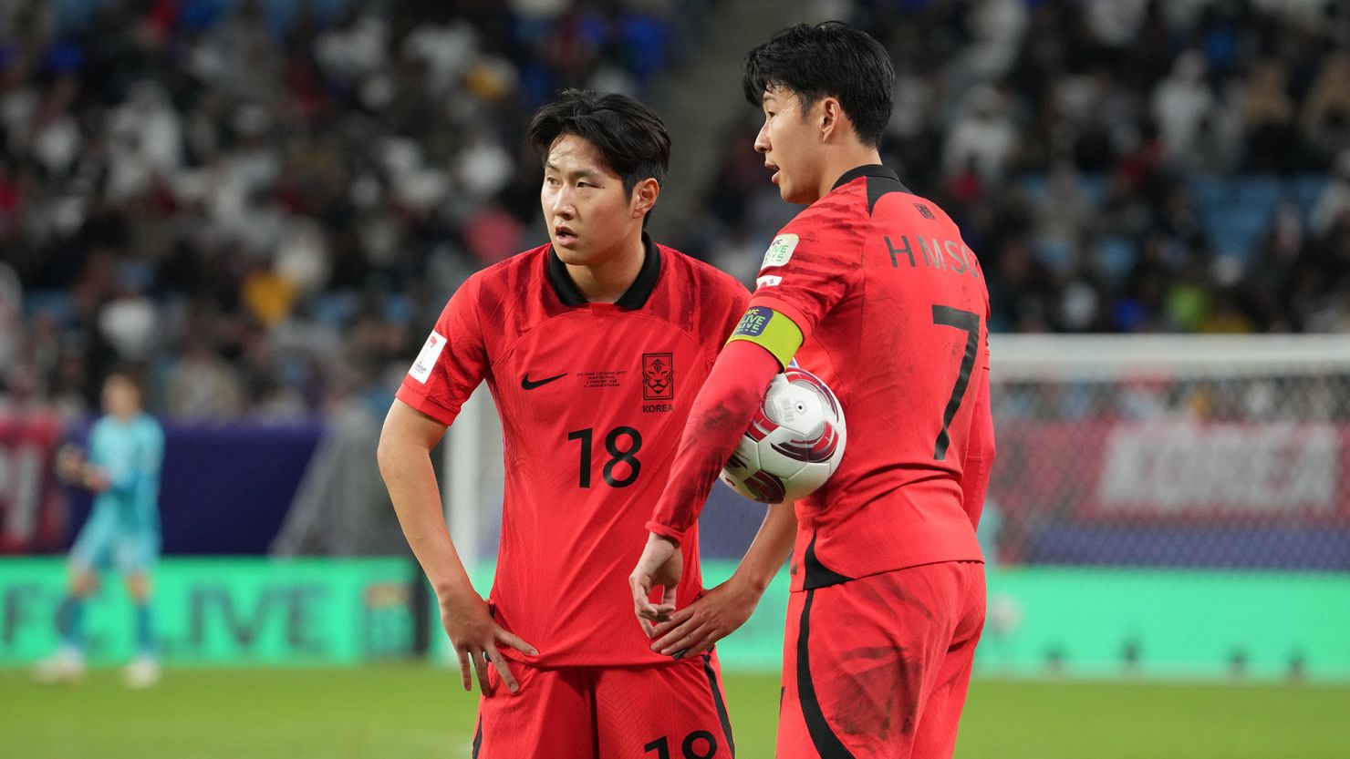 Lee (L) and Son look on during South Korea's Asian Cup quarterfinal against Australia.