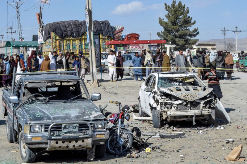 People gathered at the site of a bomb blast outside the office of an independent candidate in Pishin district, around 50 kilometres (30 miles) from Quetta on February 7, 2024, on the eve of Pakistan's national elections. At least 24 people were killed on February 7 by two separate bomb blasts outside the offices of election candidates in southwestern Pakistan, on the eve of a national vote marred by violence and allegations of poll rigging. More than half a million security officers were deploying ahead of February 8 election, with authorities distributing ballot papers to more than 90,000 polling stations. (Photo by Banaras KHAN / AFP) (Photo by BANARAS KHAN/AFP via Getty Images)
