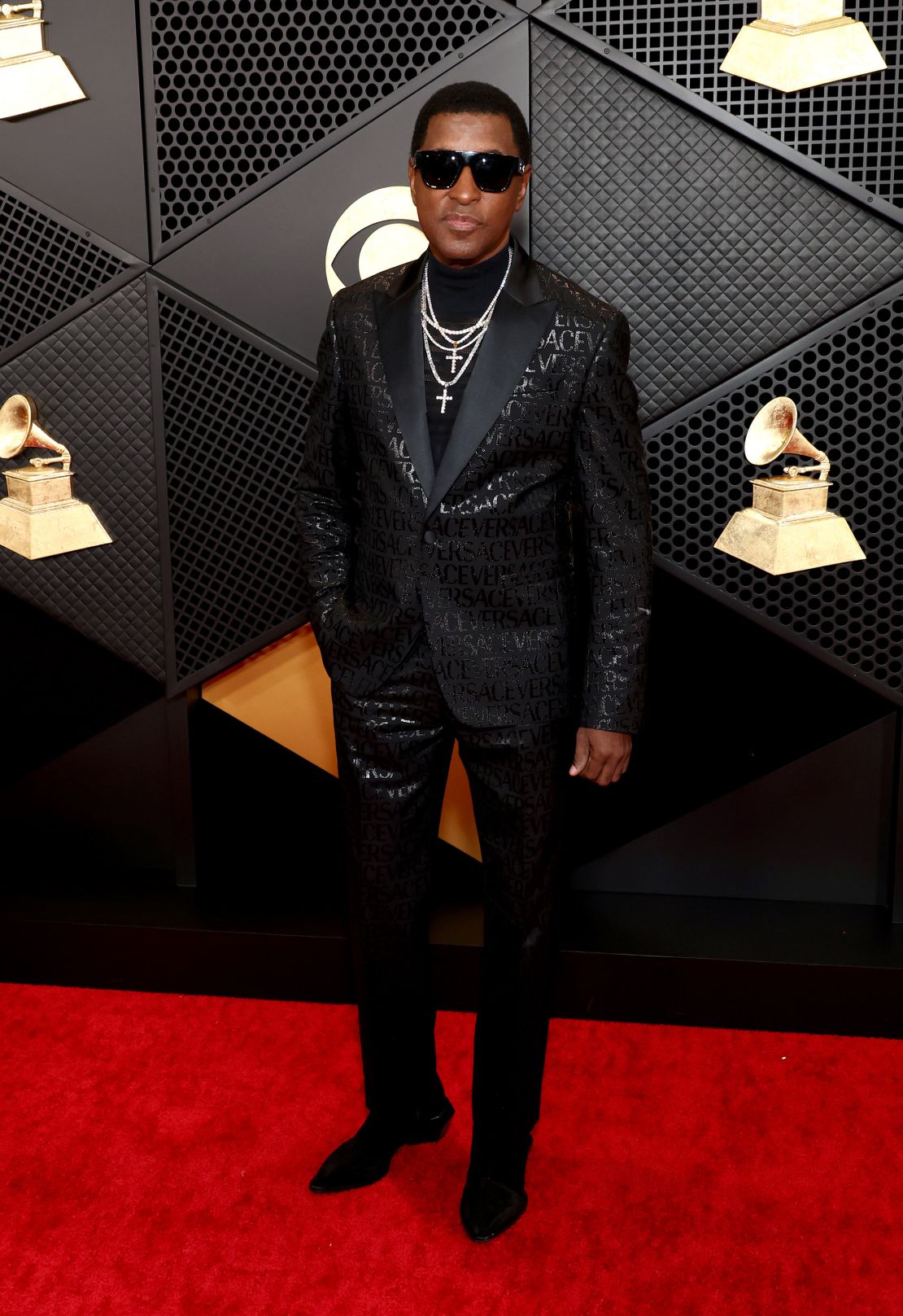 Triple nominee Babyface in an all-black Versace outfit.