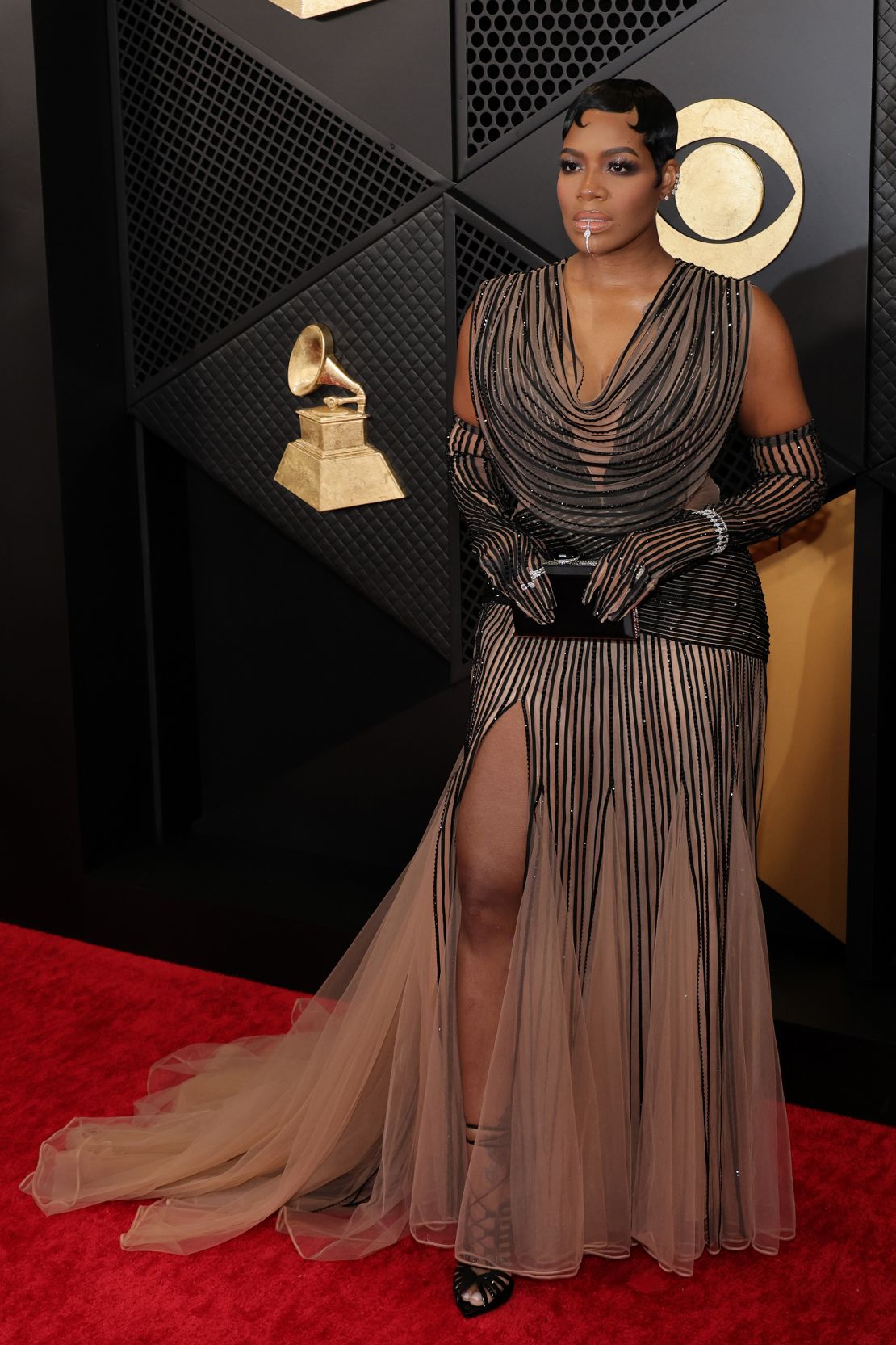 Fantasia Barrino arrived in a dress by Vietnamese fashion designer Cong Tri with matching opera gloves.