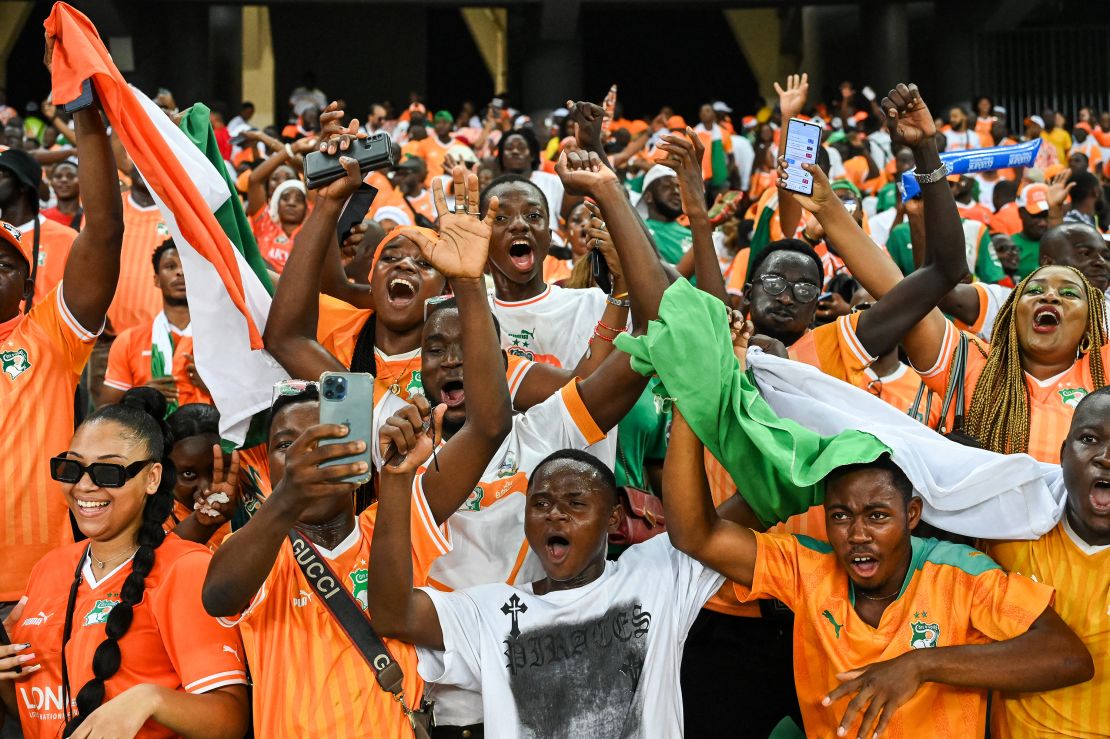 Ivory Coast's supporters celebrate their victory at the end of the match.
