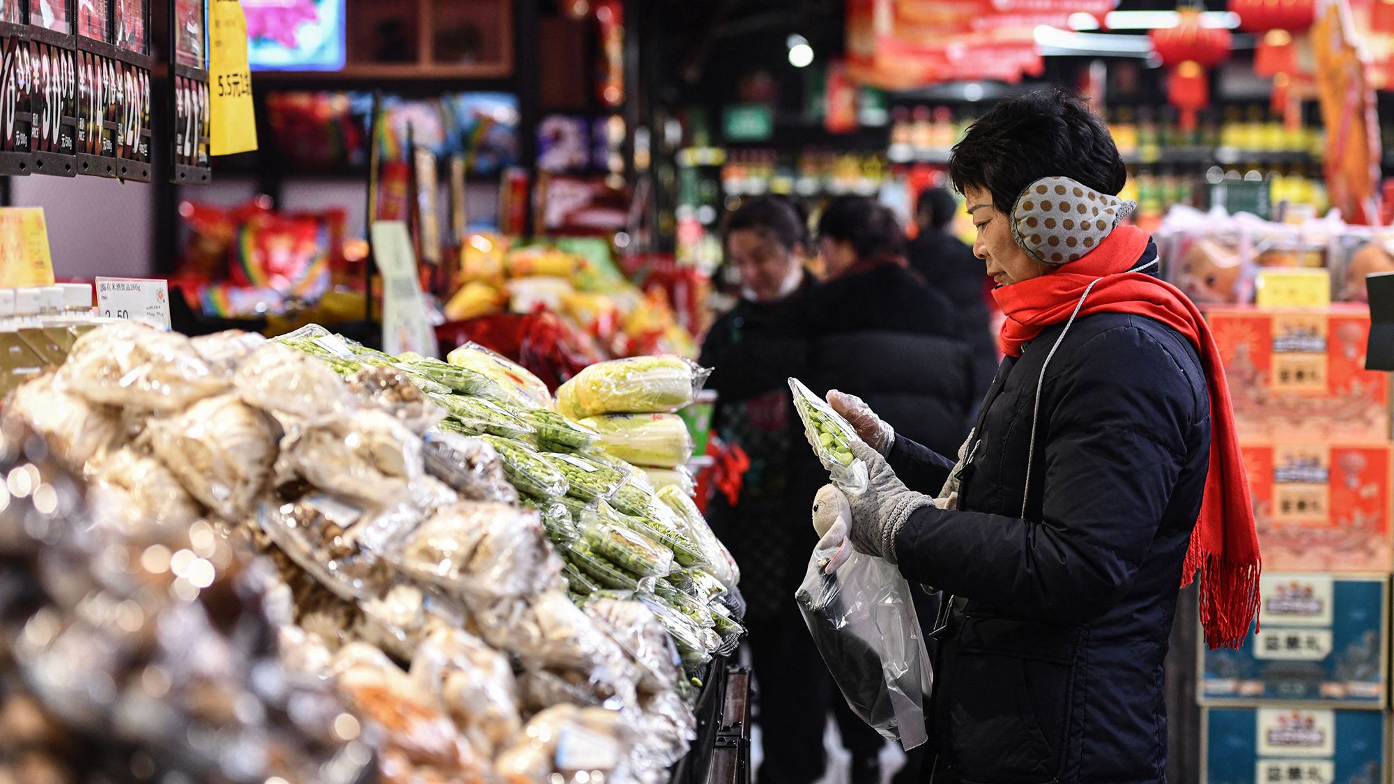 Customers shop for vegetables and fruit at a supermarket in Fuyang, China, on February 8, 2024.